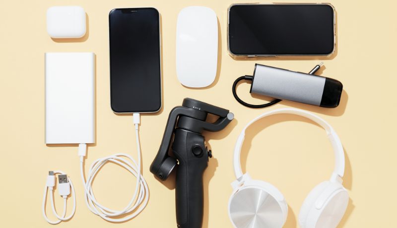 A collection of electronic gadgets and accessories arranged neatly on a light-colored surface.